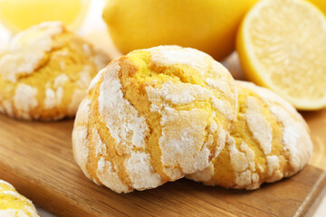 Tasty homemade lemon cookies on wooden board, closeup