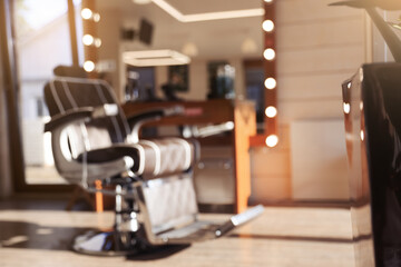 Blurred view of stylish barbershop interior with hairdresser workplace