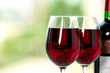 Fotobehang Glasses of delicious red wine on blurred background, closeup. Space for text © New Africa