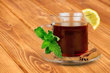 Ice tea with mint in cup with fresh mint leaves around. Homemade cold refreshing drink. © BillionPhotos.com