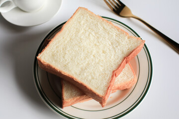 Slice Bread with hot coffee and marshmallow on white background.  Morning breakfast with coffee, butter and toasts.