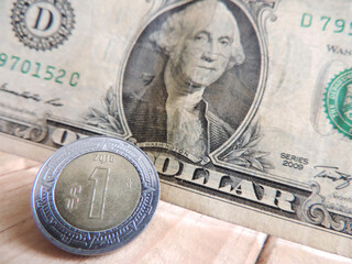 Mexican coin and a dollar bill , horizontal