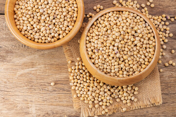 Soybeans in a wooden bowl. Placed on a wooden table. 100% protein concept. Healthy food. Agricultural products. soybean oil or milk