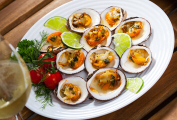 European bittersweet clam appetizers with lime, greens and vegetables