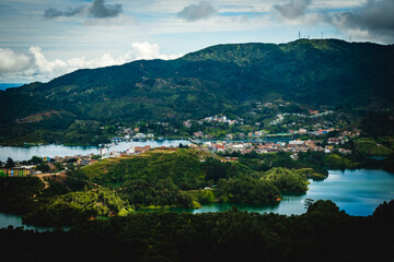 Fototapeta na wymiar Aerial Drone Fly Above Guatape Town Hills Medellin Colombia in a Cloudy Morning Mystical Sky