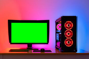 Professional workstation and gaming computer, to play video games online or do professional design and multimedia work. In a room with colorful neon led lights. - obrazy, fototapety, plakaty