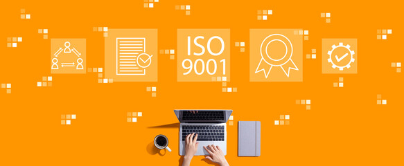 ISO 9001 concept with person working with laptop - obrazy, fototapety, plakaty