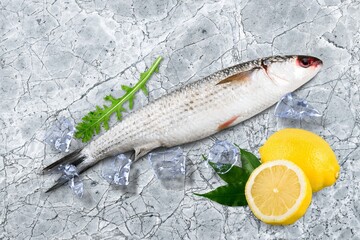 Fresh tasty fish for cooking dish on table with lemon
