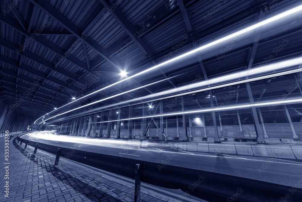 Poster light trails and head lights of traffic in tunnel. transportation background