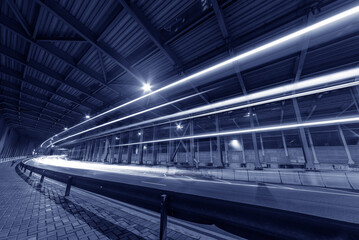 Naklejka premium light trails and head lights of traffic in tunnel. Transportation background