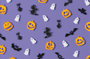 Purple pattern made of bats, witches, ghosts and jack-o'-lantern .  Creative  Minimal Halloween concept. Flat lay.