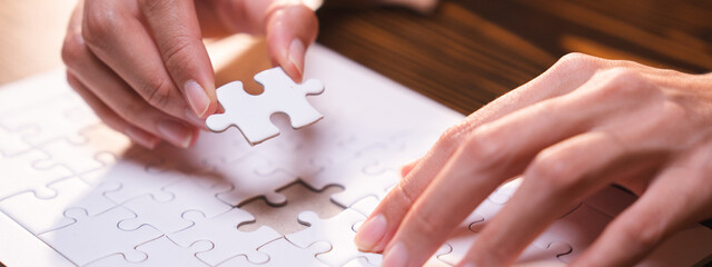 Concept of integration and startup with puzzle pieces merger with teamwork of business worker...