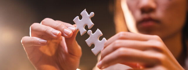 Concept of integration and startup with puzzle pieces merger with teamwork of business worker partners hand close-up, positive connection partnership in modern office for business marketing job work