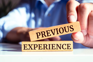 Wooden blocks with words 'PREVIOUS EXPERIENCE'. Business concept