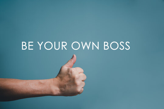 BE YOUR OWN BOSS written word with hand thumps up and copy space.