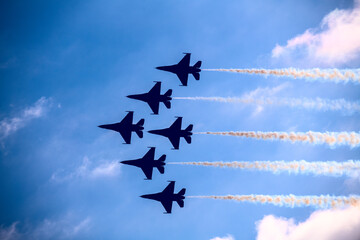 Fighter jets in formation flying past clouds - obrazy, fototapety, plakaty