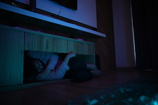 man in dipression hiding himself in a room