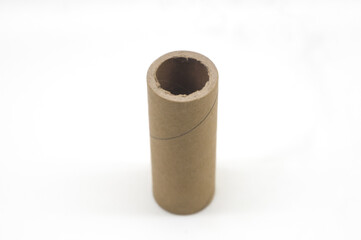 Cardboard core of different sizes for winding various strips of material in the printing house. Industrial paper core, tube and spool on a white background. Selective focus