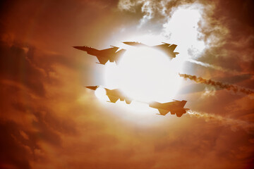 Fighter jets in formation flying past clouds