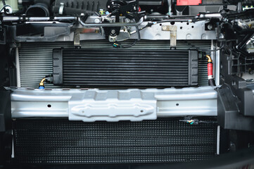 Close-up of universal automatic transmission oil cooler installed at the front of vehicle. - obrazy, fototapety, plakaty