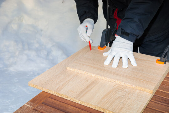 Carpenter working on two slices of wood