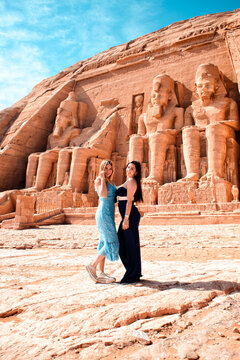 Two women posing near Abu Simbel Egyptian temple in Egypt