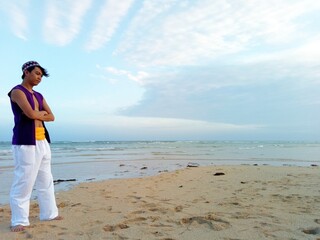 Woman in white skirt standing on beach