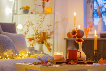 cup of tea and  autumnal leaves in cozy interior