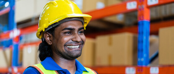 Portrait of African worker in safety uniform smiling to camera standing in the warehouse...