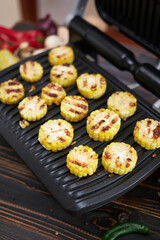 cooking at home on electric grill - sliced corn cobs