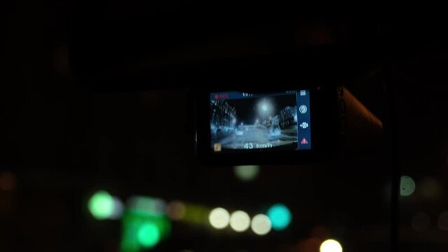 The DVR works in the car. Automol moves through the night city. Night lights of the big city