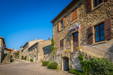 Fototapeta na wymiar street of Boucieu Le Roi, with beautiful stone medieval stone houses with colorful shutters in Ardeche (France)