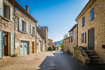 Fototapeta na wymiar street of Boucieu Le Roi, with beautiful stone medieval stone houses with colorful shutters in Ardeche (France)