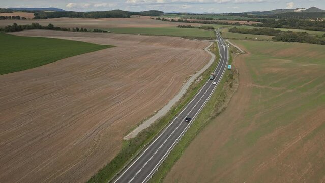 Aerial view of a modern road crossing fertile fields in the Czech countryside