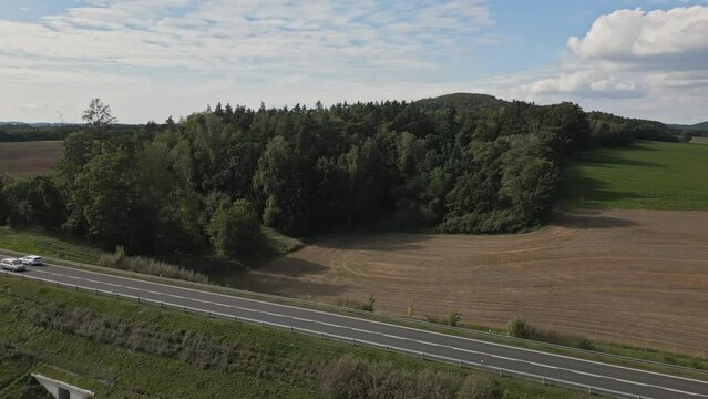 Straight road with light traffic crossing the Czech countryside
