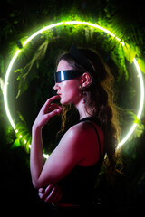 Caucasian woman in panoramic sunglasses against the background of an annular neon lamp in plants. 
