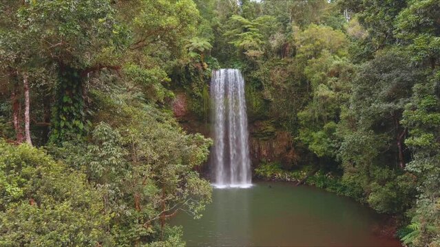 Aerial dolly in shot getting close to a waterfall in North Queensland, Milla Milla Falls
