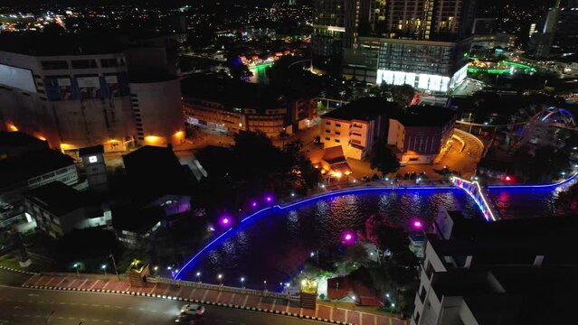 An aerial shot of an old city view of Malacca, a site showing rivers, buildings, streets, people and so on at night