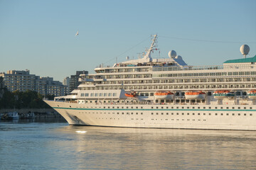 Phoenix cruiseship or cruise ship liner Amera in port of Montreal, Canada on sunny day on St. Lawrence River for Indian summer East Coast cruising with downtown skyline and terminal