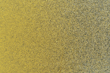 macro photography of black and yellow spray paint on white paper