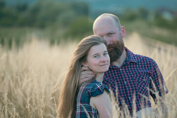 Fototapeta premium Young couple in love in the summer field