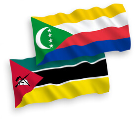 Obraz premium National vector fabric wave flags of Republic of Mozambique and Union of the Comoros isolated on white background. 1 to 2 proportion.