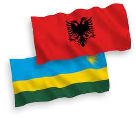 National vector fabric wave flags of Republic of Rwanda and Albania isolated on white background. 1 to 2 proportion.