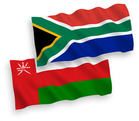 National vector fabric wave flags of Sultanate of Oman and Republic of South Africa isolated on white background. 1 to 2 proportion.