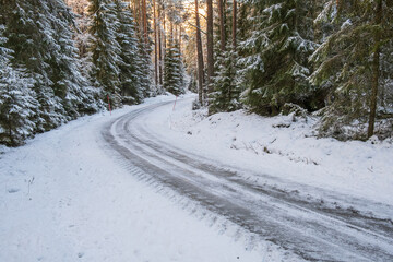 Slippery winter road in a woodland