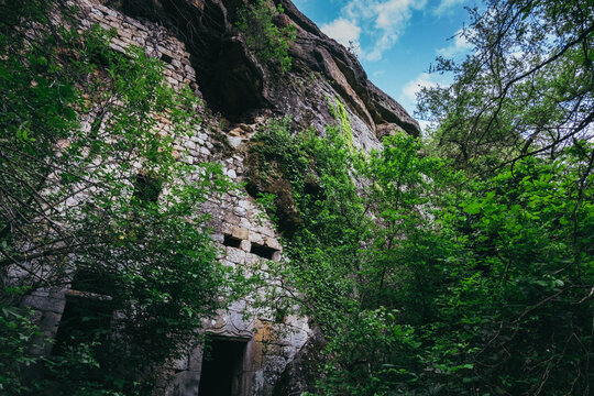 view on the facade of an abandoned troglodyte house in La Jaubernie, near Coux, Ardeche (south of France)