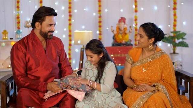 Small North Indian Family In The Living Room - Family Bonding  Happy Indian Family During Festival  Nuclear Family. Young Indian Father Offering Diwali Gift To Her Daughter - Diwali Celebrations  H...