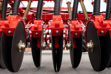 Precision seeder discs close-up for industrial design. Modern Modified Agricultural Seeder. - obrazy, fototapety, plakaty