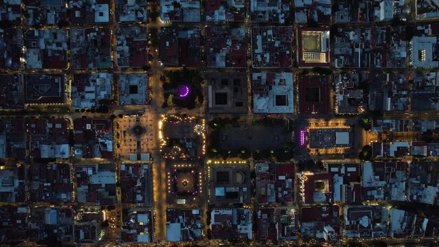 Aerial view above the illuminated Guadalajara Cathedral, night in Mexico - top down, drone shot