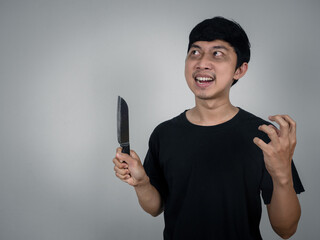 Horror man murder holding knife looking at copy space